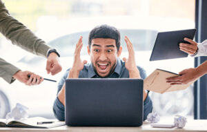 Stressed office worker overwhelmed by multiple tasks from coworkers.