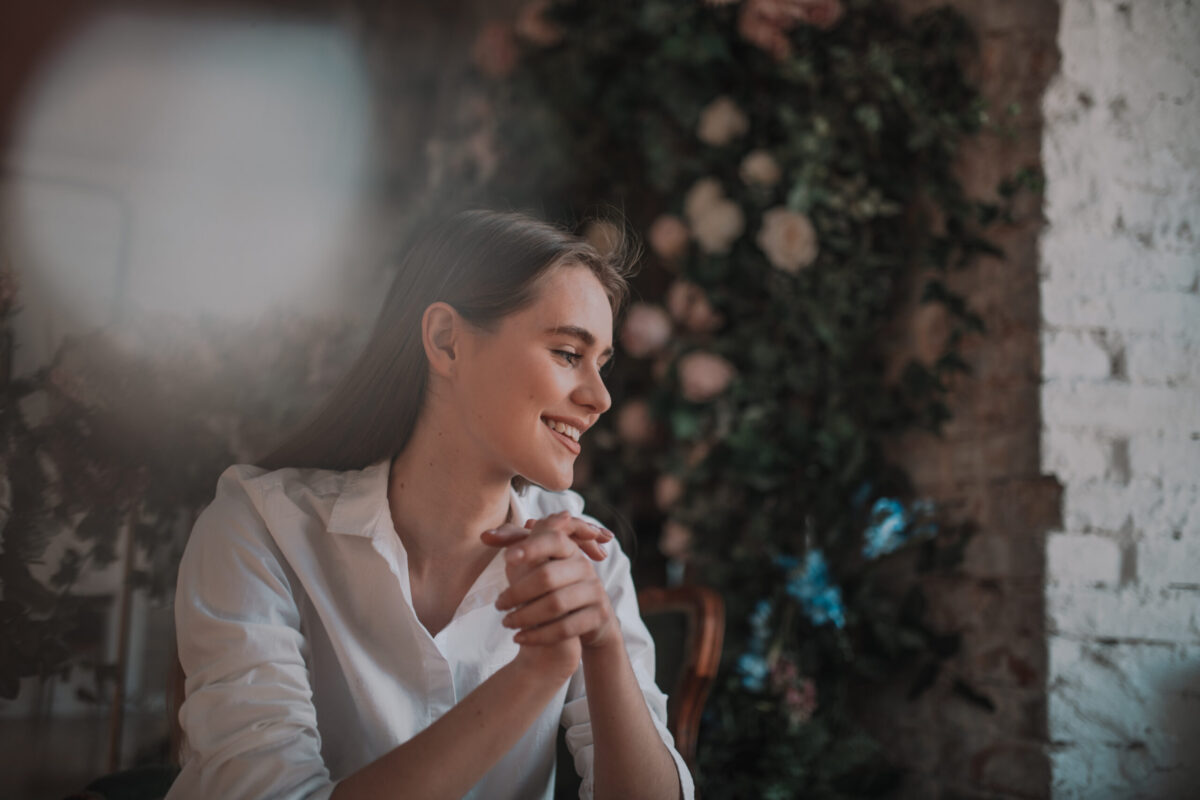 Smiling woman practicing gratitude and appreciation to improve mental and physical health