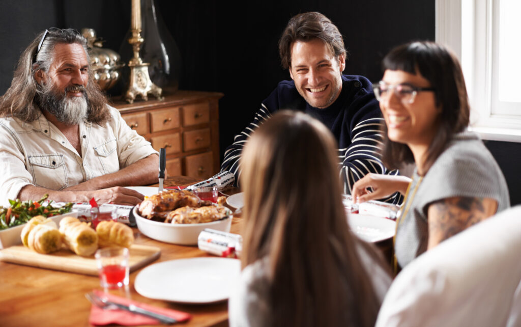 Family laughing together after a conversation starter focused on mental health strategies and family health