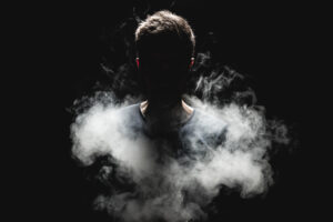 Silhouetted figure emerging from smoke symbolizing uncovering the unconscious self and new years growth