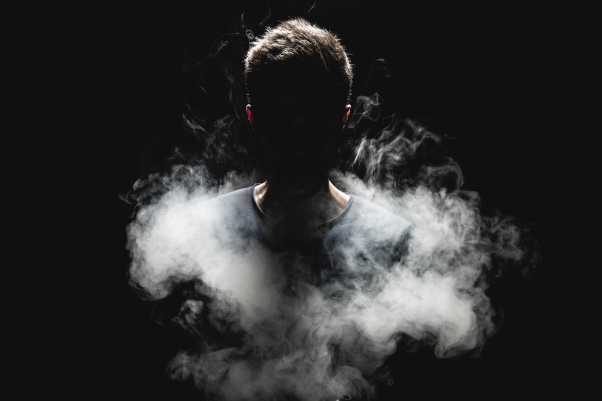 Silhouetted figure emerging from smoke symbolizing uncovering the unconscious self and new years growth
