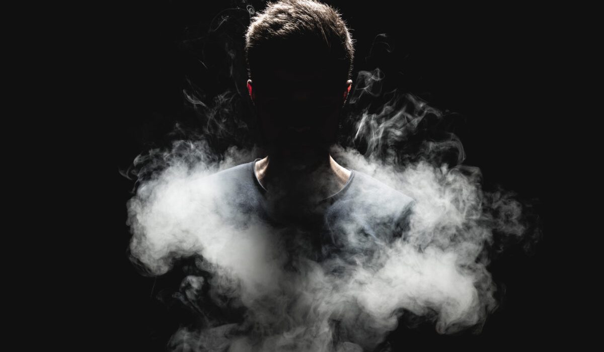 Silhouetted figure emerging from smoke symbolizing uncovering the unconscious self and new years growth