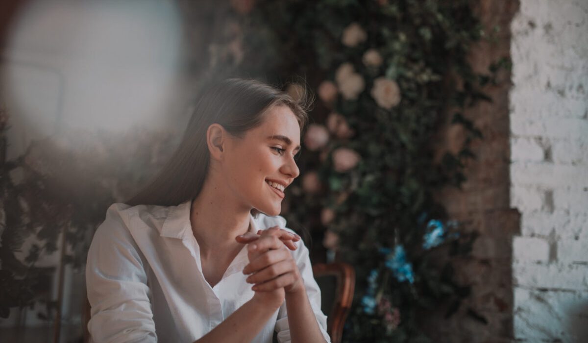 Smiling woman practicing gratitude and appreciation to improve mental and physical health